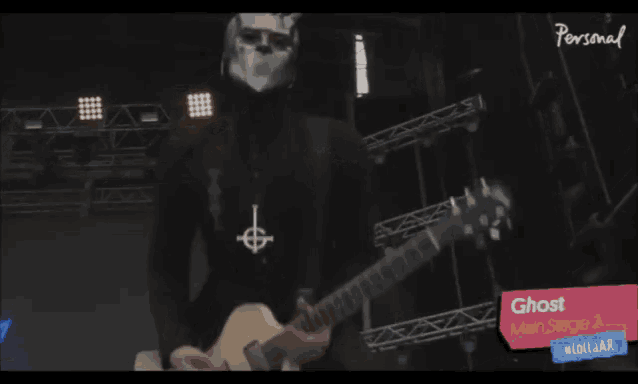 a person wearing a mask with horns is on a stage with a sign that says personal