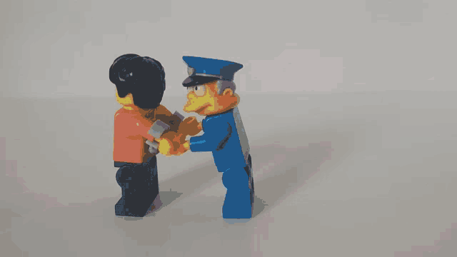 a lego figure is laying down with a gold axe on his back