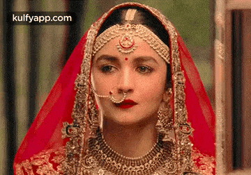 a close up of a woman in a wedding dress with a nose ring .