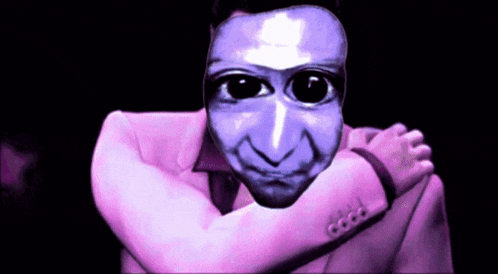 a man in a pink suit has a blue face on his face