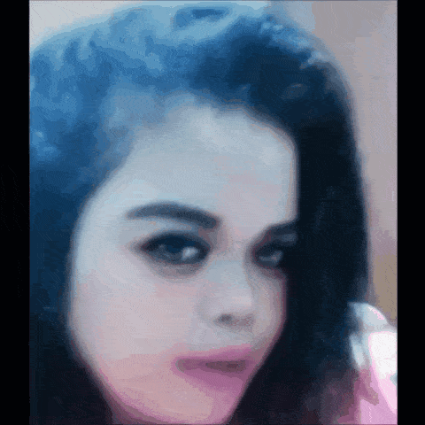 a close up of a woman 's face with blue hair and a pink lip