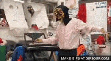 a person in a mask is dancing in front of a keyboard with the words make gifs at gifsoup.com on the bottom