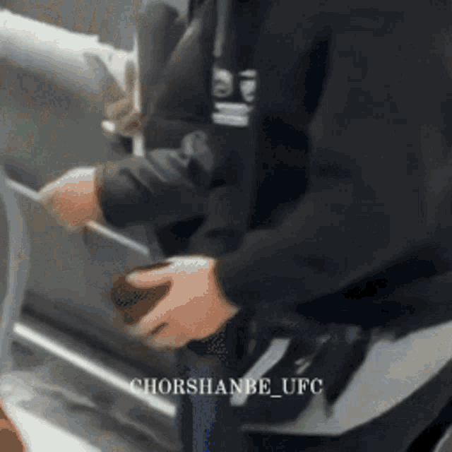 a man in a black sweatshirt with the word ufc on the back