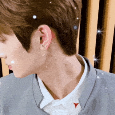 a close up of a person 's neck and ear with a red arrow pointing to the right