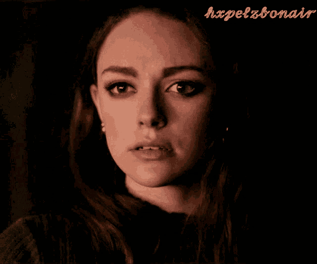 a close up of a woman 's face with the words hxpelzbonair below it