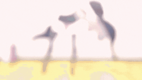 a blurred image of a person standing on a table with their legs crossed .