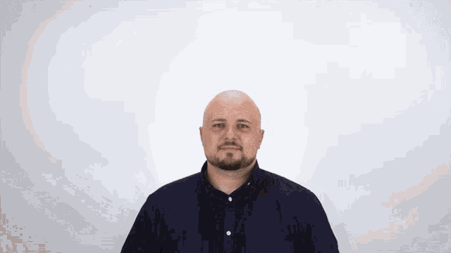 a bald man with a beard wearing a black shirt