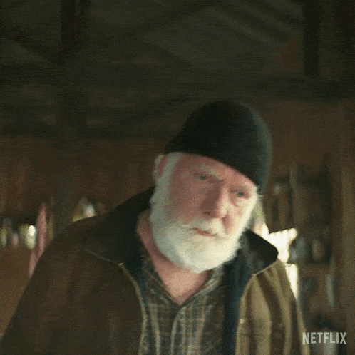 a man with a beard wearing a black beanie and a jacket says listen man