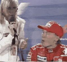 a woman is talking into a microphone next to a man wearing a red hat that says marlboro