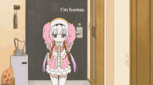 a girl in a pink and white dress is standing in front of a door that says " i 'm home "