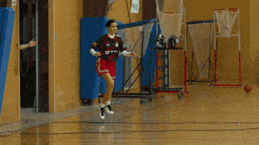 a female basketball player wearing a otl jersey dribbles the ball