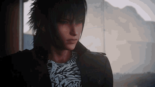 a man with long black hair is wearing a black jacket and a white t-shirt .
