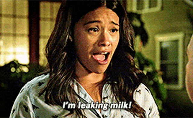 a woman is saying i 'm leaking milk while wearing pajamas .