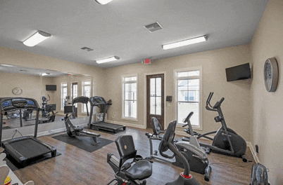 a gym with treadmills and exercise bikes