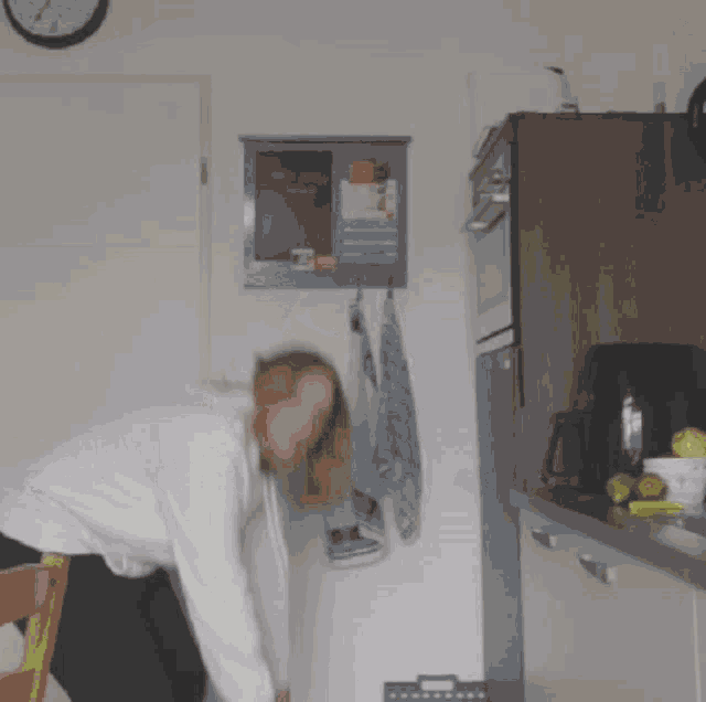 a kitchen with a clock on the wall and a sign on the wall that says ' clock '