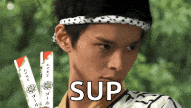 a man wearing a headband and holding chopsticks has the word sup in front of him