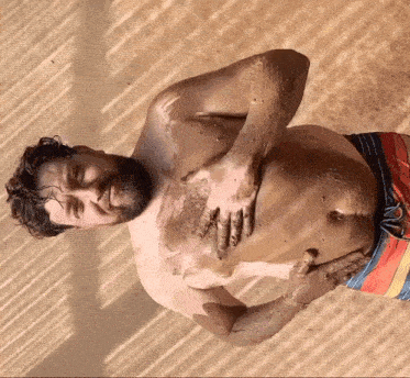 a man with a beard is covered in dirt