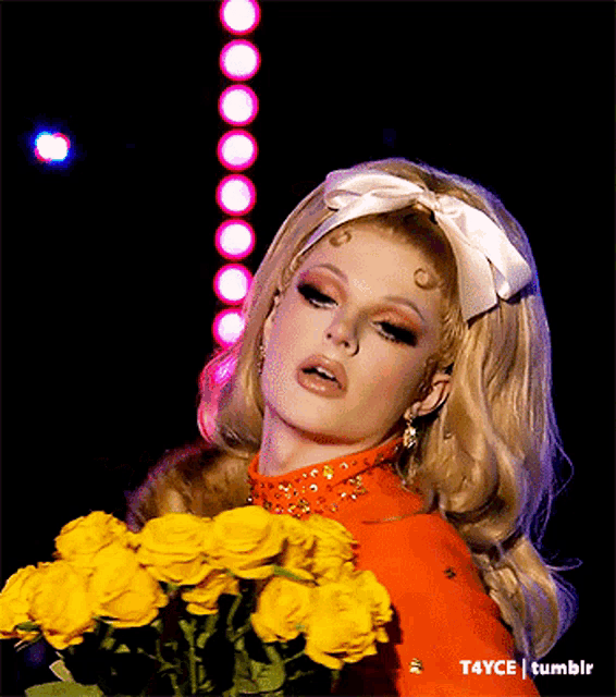 a woman is holding a bouquet of yellow roses in front of a t4yce tumblr logo
