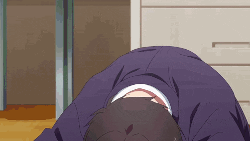 a man in a suit is laying on his back with his head down
