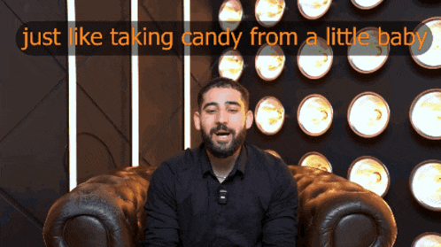a man sitting in a chair with the words just like taking candy from a little baby