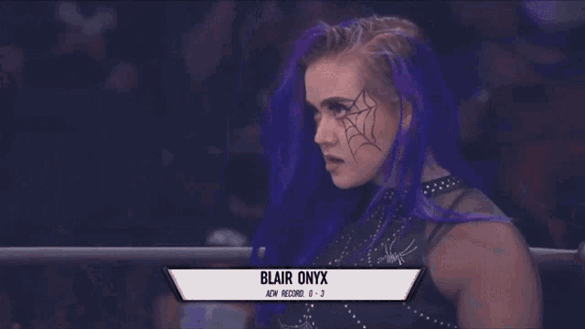 a woman with purple hair and a name tag that says blair onyx on it