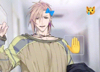 a man with a bow in his hair is wearing a sweater and giving a peace sign .