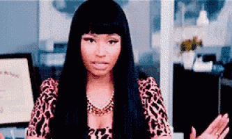a woman with long black hair is wearing a leopard print top and necklace .