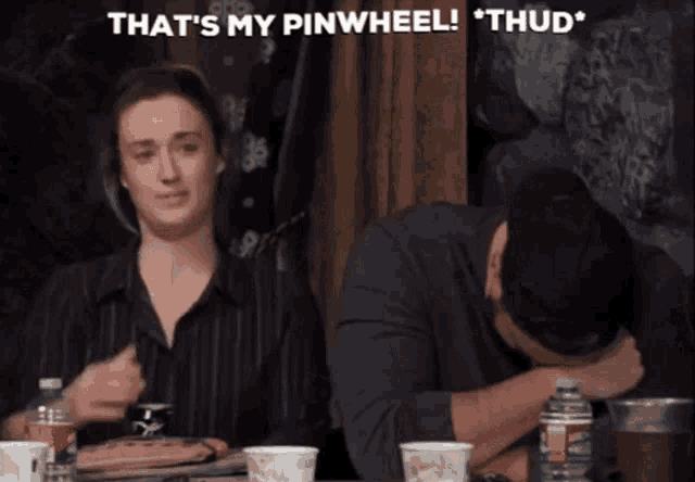 a man and a woman are sitting at a table and the man says that 's my pinwheel " thud "