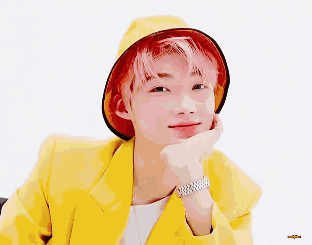 a young man with pink hair wearing a yellow jacket and hat