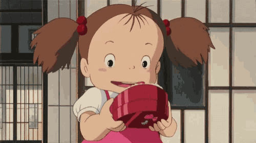 a cartoon girl is holding a red box in her hands and smiling .