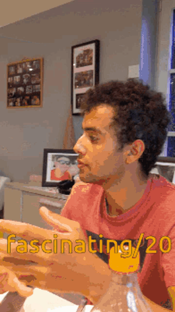 a man sitting at a table with the words fascinating / 20 written on the bottom