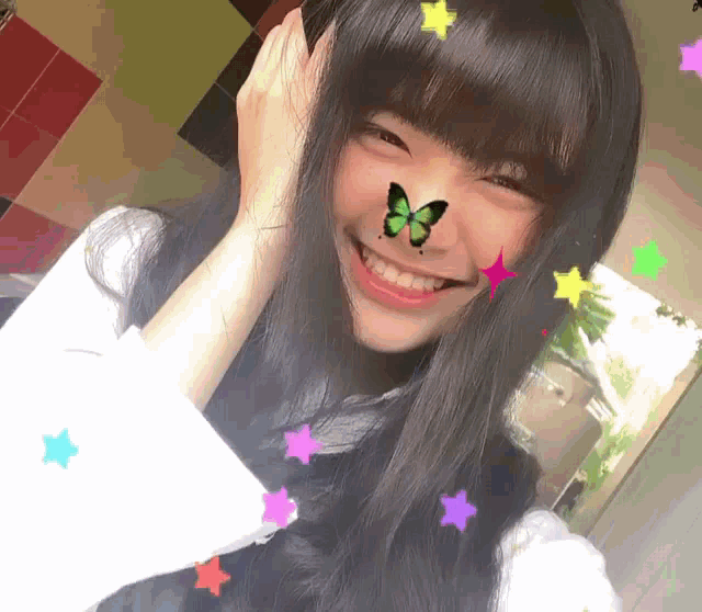 a girl with a butterfly on her face and stars on her hair
