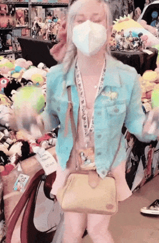 a woman wearing a mask and a lanyard that says ' disney ' on it