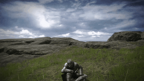 a knight in armor sits in a field of grass