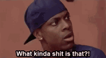 a man wearing a blue hat is saying what kinda shit is that .