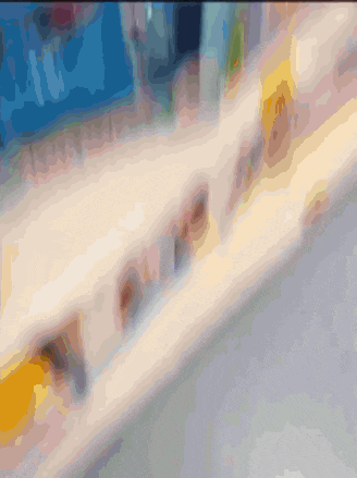 a blurred image of a store shelf with a sign that says ' coca cola '