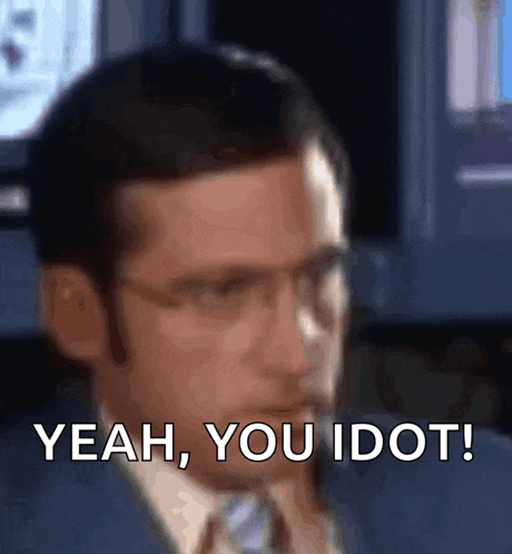 a man in a suit and tie is talking on a cell phone .