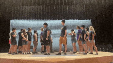 a group of people standing on a stage with a man wearing a shirt that says ' ucsd '