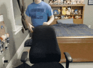 a man wearing a blue shirt that says ' nba ' on it