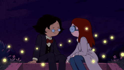 a man and a woman are sitting next to each other and looking at each other
