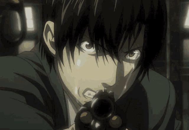 a close up of a man holding a gun in his hand