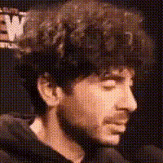 a close up of a man 's face with a beard