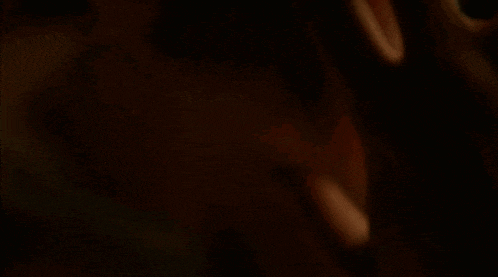 a close up of a man 's face with his eyes closed and his ear visible .