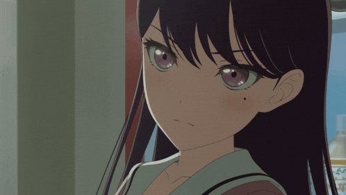 a close up of a girl 's face with a black spot on her ear