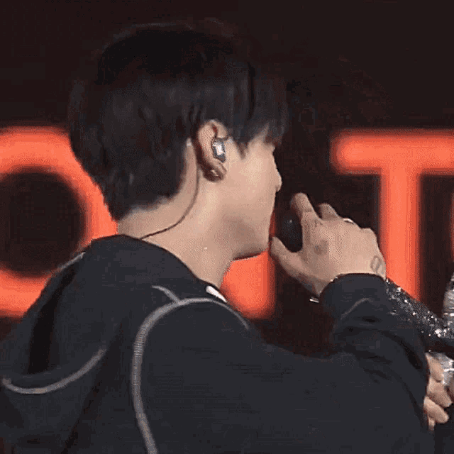 a man holding a microphone next to another man