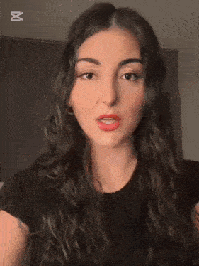 a woman in a black shirt with the word capcut in the corner