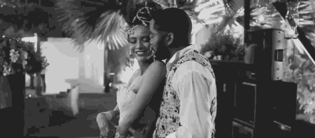 a black and white photo of a man and woman hugging