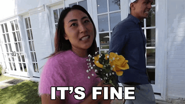 a woman holding a bouquet of flowers says it 's fine while standing next to a man