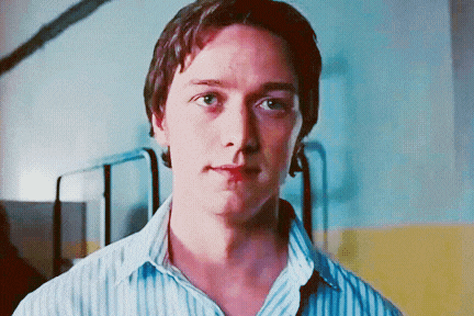 a close up of a man 's face with a striped shirt on