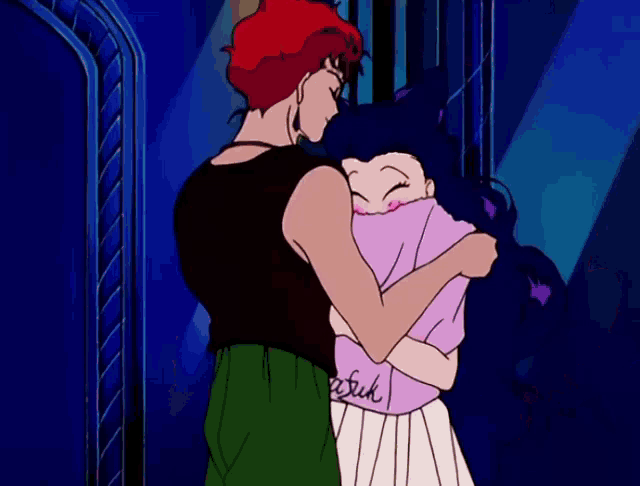 a man is hugging a woman with a shirt that says fuck
